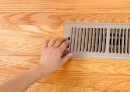 hand closing a heating register